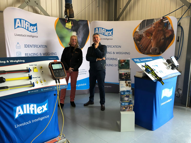 Allflex Curved Tension Display Stands Two curved tension display stands at an event