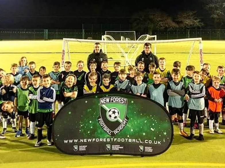 Football team stood behind a pop out banner