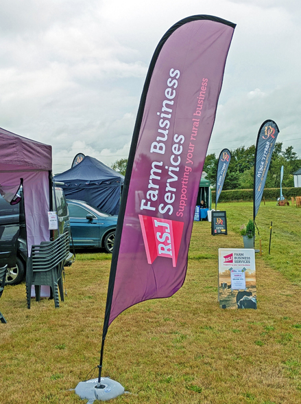 RSJ Farm Business Services feather flag displayed alongside gazebo at Holsworthy Agricultural Show