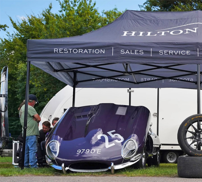 Hilton & Moss 3m x 6m Printed Gazebo with black anodised Hex 50 frame sheltering a classic race car with its bonnet raised