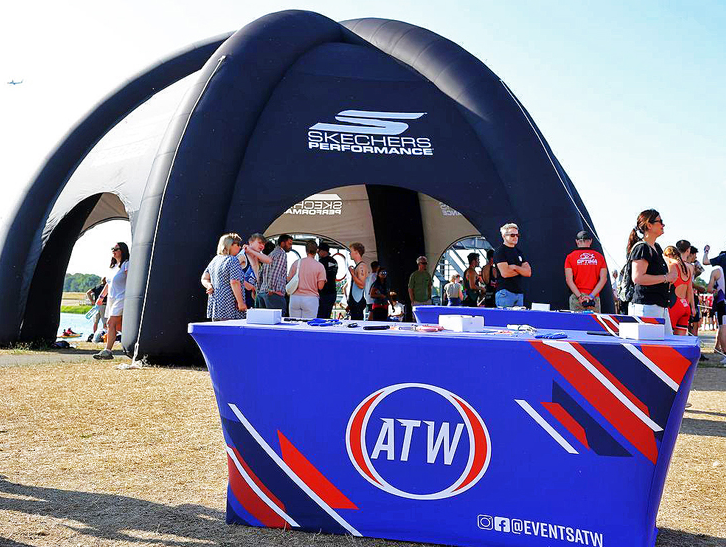 Custom inflatable dome tent with sponsor branding and ATW registration area